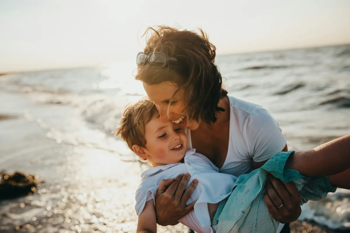 Mother and son at the beach having fun.